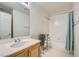 Traditional bathroom featuring a single sink vanity, shower/tub combo and tiled floors at 10808 Wallflower Ave, Las Vegas, NV 89135