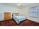 Bedroom with a neutral palette that includes a single bed, carpet, and wooden dresser at 10808 Wallflower Ave, Las Vegas, NV 89135
