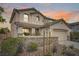 Charming two-story home with a two-car garage, landscaped yard, and decorative stone wall at 10808 Wallflower Ave, Las Vegas, NV 89135