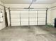 Two car garage with white door and concrete flooring, ready for your vehicles and storage at 10808 Wallflower Ave, Las Vegas, NV 89135