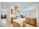 Bright kitchen featuring light wood cabinets, tiled floors, an island, and an adjacent dining area at 10808 Wallflower Ave, Las Vegas, NV 89135