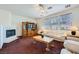 Cozy living room boasts a fireplace, built-in cabinet, and large windows that provide ample natural light at 10808 Wallflower Ave, Las Vegas, NV 89135
