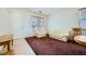 Bright living room with carpet, lots of natural light, and neutral-toned furniture at 10808 Wallflower Ave, Las Vegas, NV 89135