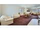 Spacious living room with a full dining room set that leads to a second open seating area at 10808 Wallflower Ave, Las Vegas, NV 89135