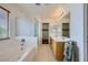 Bright main bathroom has a soaking tub, walk-in shower, dual sinks, and walk-in closet at 10808 Wallflower Ave, Las Vegas, NV 89135