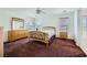 Bright main bedroom featuring a ceiling fan, carpet, and matching wood furniture set at 10808 Wallflower Ave, Las Vegas, NV 89135