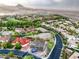 Expansive aerial view of a development area featuring homes and lake views, set against a backdrop of scenic mountains at 18 Placa De Rei Ct, Henderson, NV 89011