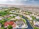 An aerial captures a residential area amid desert terrain, highlighting the neighborhood's layout and scenic mountain backdrop at 18 Placa De Rei Ct, Henderson, NV 89011