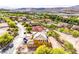 Aerial view showcases a two-story home in a neighborhood with lake and mountain views at 18 Placa De Rei Ct, Henderson, NV 89011