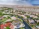 Neighborhood aerial shot displaying a desert landscape and many homes, set against a mountain backdrop on a cloudy day at 18 Placa De Rei Ct, Henderson, NV 89011