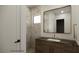 Ensuite bathroom showcasing a stylish vanity with marble counters and tiled shower with river rock floor at 18 Placa De Rei Ct, Henderson, NV 89011