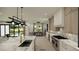 Spacious open dining area with natural light, view of pond and modern light fixture at 18 Placa De Rei Ct, Henderson, NV 89011