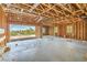 Spacious garage under construction with exposed framing and scenic outdoor view, awaiting customization and finishing touches at 18 Placa De Rei Ct, Henderson, NV 89011