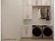 Functional laundry room with modern washer and dryer, ample cabinet space, and elegant marble accents at 18 Placa De Rei Ct, Henderson, NV 89011