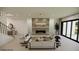 Modern living room features elegant seating, a fireplace with stone accents, and sliding glass doors with backyard views at 18 Placa De Rei Ct, Henderson, NV 89011