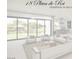 Bright living room with modern furnishings and a view of the landscaped backyard featuring lake and treehouse at 18 Placa De Rei Ct, Henderson, NV 89011