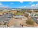 Aerial view of a commercial property featuring parking, buses, a large grass playing field and Las Vegas in the background at 2130 E Maule Ave, Las Vegas, NV 89119
