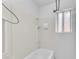 A bathroom with a shower-tub combo, a window, and all-white fixtures, offering a simple, clean design at 2130 E Maule Ave, Las Vegas, NV 89119