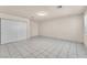 A light, bright bedroom with white floors, and a closet with sliding doors at 2130 E Maule Ave, Las Vegas, NV 89119
