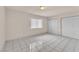 Cozy bedroom featuring tile flooring, window, and double closets, combining comfort and practicality at 2130 E Maule Ave, Las Vegas, NV 89119