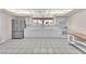 An airy kitchen with stainless steel refrigerator, white cabinets, and tile flooring, perfect for culinary adventures at 2130 E Maule Ave, Las Vegas, NV 89119