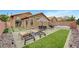 Relaxing backyard oasis with patio, hot tub, artificial grass, and lounge chairs at 228 Mchenry St, Las Vegas, NV 89144