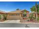 Charming single-story home with a well-manicured front yard and two-car garage at 228 Mchenry St, Las Vegas, NV 89144