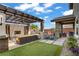 Beautiful backyard with a fireplace, outdoor seating, and a lush lawn perfect for entertaining at 5742 Shadow Bend Dr, Las Vegas, NV 89135