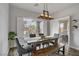 Bright dining room with a large window, modern lighting, and access to an outdoor patio at 5742 Shadow Bend Dr, Las Vegas, NV 89135