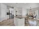 Well-lit kitchen with stainless steel appliances, an island with bar seating, and a view into the dining area at 5742 Shadow Bend Dr, Las Vegas, NV 89135