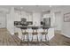 Open kitchen featuring white cabinets, granite countertops, stainless appliances, and a convenient breakfast bar at 5742 Shadow Bend Dr, Las Vegas, NV 89135
