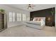 Spacious main bedroom with a tufted headboard and plantation shutters at 5742 Shadow Bend Dr, Las Vegas, NV 89135