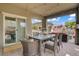 Inviting outdoor dining area adjacent to a living space, perfect for relaxing and enjoying the outdoors at 5742 Shadow Bend Dr, Las Vegas, NV 89135