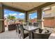 Covered outdoor dining area with a glass table and seating for six, perfect for entertaining at 5742 Shadow Bend Dr, Las Vegas, NV 89135