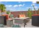 Stylish outdoor seating area with a modern fire pit and desert landscaping at 5742 Shadow Bend Dr, Las Vegas, NV 89135