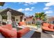 Comfortable outdoor living space featuring a pergola, fire pit, seating and desert landscaping at 5742 Shadow Bend Dr, Las Vegas, NV 89135