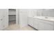 Bright bathroom featuring double sinks, a large mirror, and a separate shower at 74 Via Montoro, Henderson, NV 89011