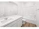 Bathroom featuring double sink vanity, and a shower-tub combo with white tile at 74 Via Montoro, Henderson, NV 89011