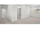 Carpeted hallway featuring multiple doorways leading to bedrooms and living areas at 74 Via Montoro, Henderson, NV 89011