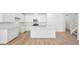 Modern kitchen featuring white cabinets, quartz counters, stainless appliances, and island at 74 Via Montoro, Henderson, NV 89011