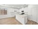 Modern kitchen with white cabinets, quartz countertops, stainless appliances, and island at 74 Via Montoro, Henderson, NV 89011