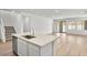 Bright kitchen island with sink and dishwasher, and an open view to the living space at 74 Via Montoro, Henderson, NV 89011