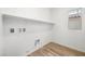 Bright laundry room featuring tile floors, overhead cabinets and a window at 74 Via Montoro, Henderson, NV 89011