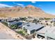 Aerial view of contemporary homes, desert landscaping, and mountain views at 10271 Meridian Hill Ave, Las Vegas, NV 89135