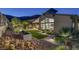 Beautiful backyard with lush landscaping, including palm trees and cacti, providing a serene and private outdoor space at 10271 Meridian Hill Ave, Las Vegas, NV 89135