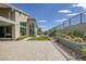This backyard features a brick patio, small patch of grass, desert landscaping, and a mountain view at 10271 Meridian Hill Ave, Las Vegas, NV 89135