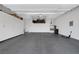 Spacious garage with epoxy flooring, ample storage cabinets, and overhead storage racks at 10271 Meridian Hill Ave, Las Vegas, NV 89135