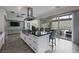 Contemporary kitchen with large island, granite countertops, stainless appliances and backyard access at 10271 Meridian Hill Ave, Las Vegas, NV 89135