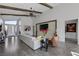 Open concept living room features high ceilings, wood beams, a modern fireplace, and lots of natural light at 10271 Meridian Hill Ave, Las Vegas, NV 89135
