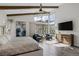 Bright main bedroom with beamed ceiling, large windows with mountain views, and a comfortable seating area at 10271 Meridian Hill Ave, Las Vegas, NV 89135